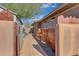 Landscaped side yard path with decorative metal gate at 18007 W Ocotillo Ave, Goodyear, AZ 85338