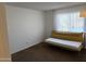 Bedroom with mustard-yellow daybed and brown carpet at 1832 N 52Nd St # 205, Phoenix, AZ 85008