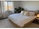 Spacious bedroom with large bed, ample light, and neutral decor at 1832 N 52Nd St # 205, Phoenix, AZ 85008