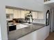 Bright kitchen features granite countertops, white cabinets, and modern appliances at 1832 N 52Nd St # 205, Phoenix, AZ 85008