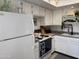 White kitchen with granite countertops and stainless steel appliances at 1832 N 52Nd St # 205, Phoenix, AZ 85008