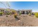 Landscaped backyard with a rock water feature at 18873 N 262Nd Dr, Buckeye, AZ 85396