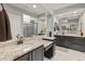 Elegant bathroom with granite countertops, double sinks, and a walk-in shower at 18873 N 262Nd Dr, Buckeye, AZ 85396