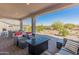 Spacious covered patio with fire pit and seating at 18873 N 262Nd Dr, Buckeye, AZ 85396