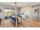 Bright dining room features a wood table, blue chairs, and an accent wall at 18873 N 262Nd Dr, Buckeye, AZ 85396