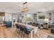 Open concept dining room with large farmhouse table and modern lighting at 18873 N 262Nd Dr, Buckeye, AZ 85396