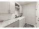 Laundry room with granite countertops and modern washer/dryer at 18873 N 262Nd Dr, Buckeye, AZ 85396