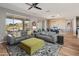 Open living space with gray sofas, yellow accents, and view of dining area at 18873 N 262Nd Dr, Buckeye, AZ 85396