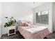 Bedroom with a pink comforter and plenty of pillows at 22125 N 29Th Ave # 127, Phoenix, AZ 85027