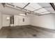 Spacious garage with concrete floor, overhead lighting, and garage door with windows at 22125 N 29Th Ave # 127, Phoenix, AZ 85027