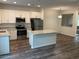 Modern kitchen features stainless appliances, granite counters, island, and wood floors at 22125 N 29Th Ave # 127, Phoenix, AZ 85027