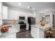 Bright kitchen features stainless steel appliances, white cabinets, and a functional center island at 22125 N 29Th Ave # 127, Phoenix, AZ 85027