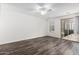 Bright living room featuring modern flooring, access to a balcony, and a ceiling fan at 22125 N 29Th Ave # 127, Phoenix, AZ 85027