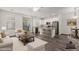 Open-concept living area with white furniture, and a sliding door leading to a balcony at 22125 N 29Th Ave # 127, Phoenix, AZ 85027