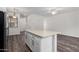 Bright living room with adjacent kitchen and dining area and modern countertops at 22125 N 29Th Ave # 127, Phoenix, AZ 85027