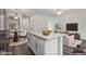 Open floorplan features a spacious kitchen island, dining area, and living space at 22125 N 29Th Ave # 127, Phoenix, AZ 85027
