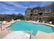 Inviting community pool with ample seating and a well-maintained deck area, set against a backdrop of desert landscape at 22125 N 29Th Ave # 127, Phoenix, AZ 85027