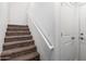 Carpeted staircase with a white handrail provides access to upper levels of the home at 22125 N 29Th Ave # 127, Phoenix, AZ 85027