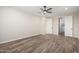 Bedroom with wood-look tile floors and access to bathroom at 23437 E Cactus Forest Rd, Florence, AZ 85132