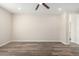 Bright bedroom with wood-look tile floors and ceiling fan at 23437 E Cactus Forest Rd, Florence, AZ 85132