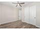 Bedroom with wood-look tile floors and double doors at 23437 E Cactus Forest Rd, Florence, AZ 85132