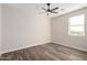 Bedroom with wood-look tile floors and ceiling fan at 23437 E Cactus Forest Rd, Florence, AZ 85132