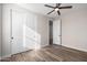 Bright bedroom with wood-look tile floors and double doors at 23437 E Cactus Forest Rd, Florence, AZ 85132