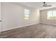 Spacious bedroom with wood-look tile floors and large window at 23437 E Cactus Forest Rd, Florence, AZ 85132