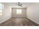 Well-lit bedroom with wood-look tile floors and window coverings at 23437 E Cactus Forest Rd, Florence, AZ 85132