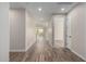 Bright hallway with wood-look tile flooring leading to other rooms at 23437 E Cactus Forest Rd, Florence, AZ 85132