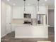 Modern kitchen with white cabinets and a large kitchen island at 23437 E Cactus Forest Rd, Florence, AZ 85132