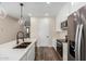 Modern kitchen with white cabinets, stainless steel appliances, and quartz countertops at 23437 E Cactus Forest Rd, Florence, AZ 85132