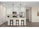 Virtually staged kitchen with white cabinets, quartz countertops, and island with seating at 23437 E Cactus Forest Rd, Florence, AZ 85132