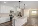 Modern kitchen with white cabinets, quartz countertops, and stainless steel appliances at 23437 E Cactus Forest Rd, Florence, AZ 85132