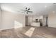 Open living room with wood-look tile floors and ceiling fan at 23437 E Cactus Forest Rd, Florence, AZ 85132