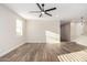 Bright living room featuring wood-look tile floors and ceiling fan at 23437 E Cactus Forest Rd, Florence, AZ 85132