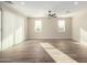 Living room with two windows, tile floors and ceiling fan at 23437 E Cactus Forest Rd, Florence, AZ 85132