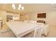 Kitchen dining area with white table and chairs, adjacent to living room at 2508 N Franz Ln, Casa Grande, AZ 85122