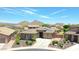 Single-story home with solar panels, a landscaped yard, and mountain views at 28957 N 70Th Dr, Peoria, AZ 85383