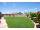 Landscaped backyard with grassy area and stone pathway at 28957 N 70Th Dr, Peoria, AZ 85383