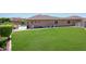 Large backyard with grassy lawn, pool, and storage shed at 28957 N 70Th Dr, Peoria, AZ 85383