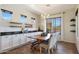 Bright dining area with a rustic farmhouse table and chandelier at 28957 N 70Th Dr, Peoria, AZ 85383