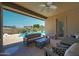 Covered patio with comfortable seating and pool view at 28957 N 70Th Dr, Peoria, AZ 85383