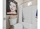 Clean bathroom with a bathtub, toilet, and Marilyn Monroe art at 2915 E Constance Way, Phoenix, AZ 85042