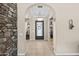 Elegant entryway with arched doorways, tile flooring, and a decorative light fixture at 2915 E Constance Way, Phoenix, AZ 85042