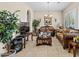 Living room with tiled floors, comfortable seating, and a large flat screen TV at 2915 E Constance Way, Phoenix, AZ 85042