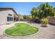 Landscaped backyard with grassy area and rock border at 3127 W Folgers Rd, Phoenix, AZ 85027