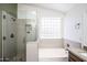 Modern bathroom featuring a walk-in shower and soaking tub at 3127 W Folgers Rd, Phoenix, AZ 85027