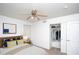 Bright bedroom featuring a ceiling fan, closet, and contemporary decor, creating a comfortable and stylish space at 3127 W Folgers Rd, Phoenix, AZ 85027