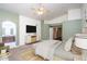Spacious bedroom with ensuite bathroom access, a ceiling fan, and a modern entertainment center, creating a luxurious ambiance at 3127 W Folgers Rd, Phoenix, AZ 85027
